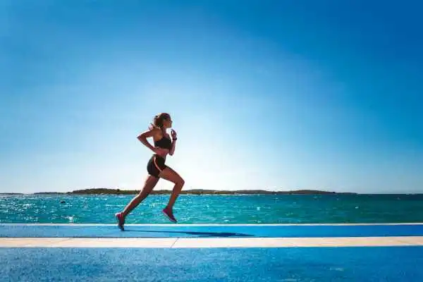Woman running showing strong leg muscle Shropshire